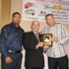 Winky Wright, FBHOF President Butch Flansburg with Dan Birmingham accepting award for brother Mike Birmingham
Photo by Tom Sisson